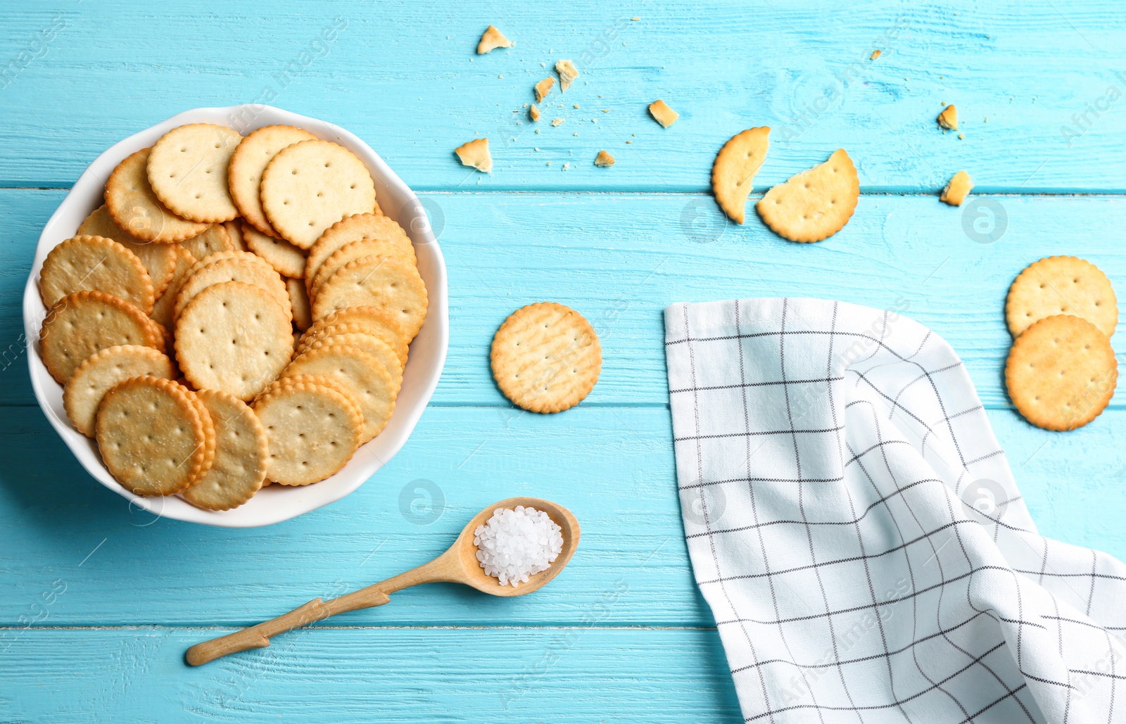 Photo of Flat lay composition with delicious crackers on turquoise wooden table