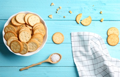 Flat lay composition with delicious crackers on turquoise wooden table