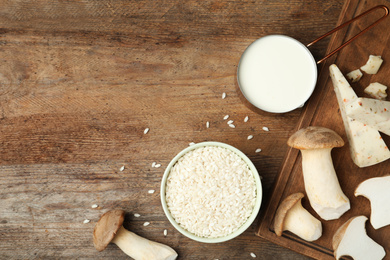 Photo of Flat lay composition with different ingredients on wooden table, space for text. Risotto recipe