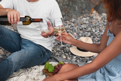 Young couple having picnic on beach, closeup