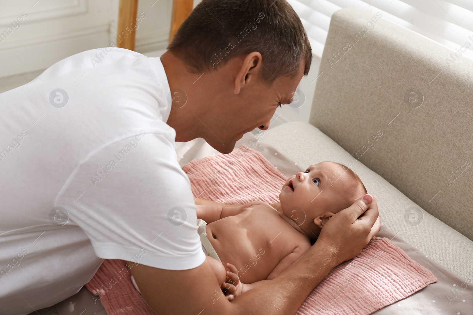 Photo of Happy father with his little baby at home