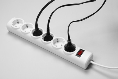 Photo of Power strip with electrical plugs on white background