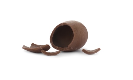 Photo of Broken milk chocolate egg on white background