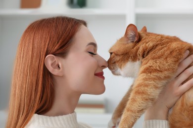 Photo of Woman with her cute cat at home