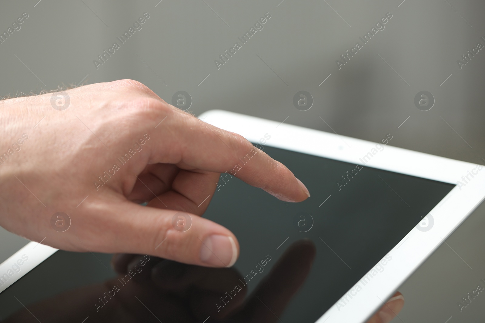 Photo of Closeup view of man using new tablet indoors