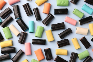 Flat lay composition of tasty liquorice candies on light blue background