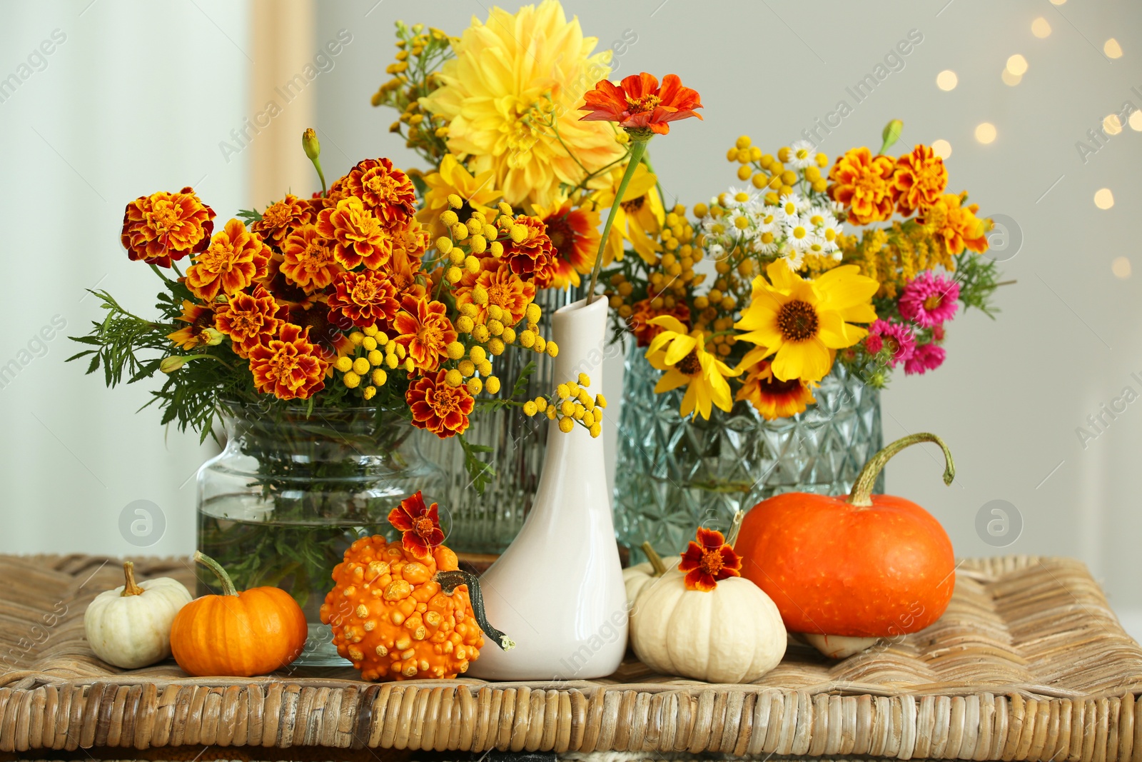 Photo of Beautiful autumn composition with pumpkins and flowers on wicker table