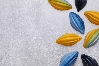 Tasty chocolate candies on light grey table, flat lay. Space for text