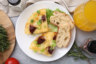 Photo of Tasty sausage casserole served on grey table, flat lay