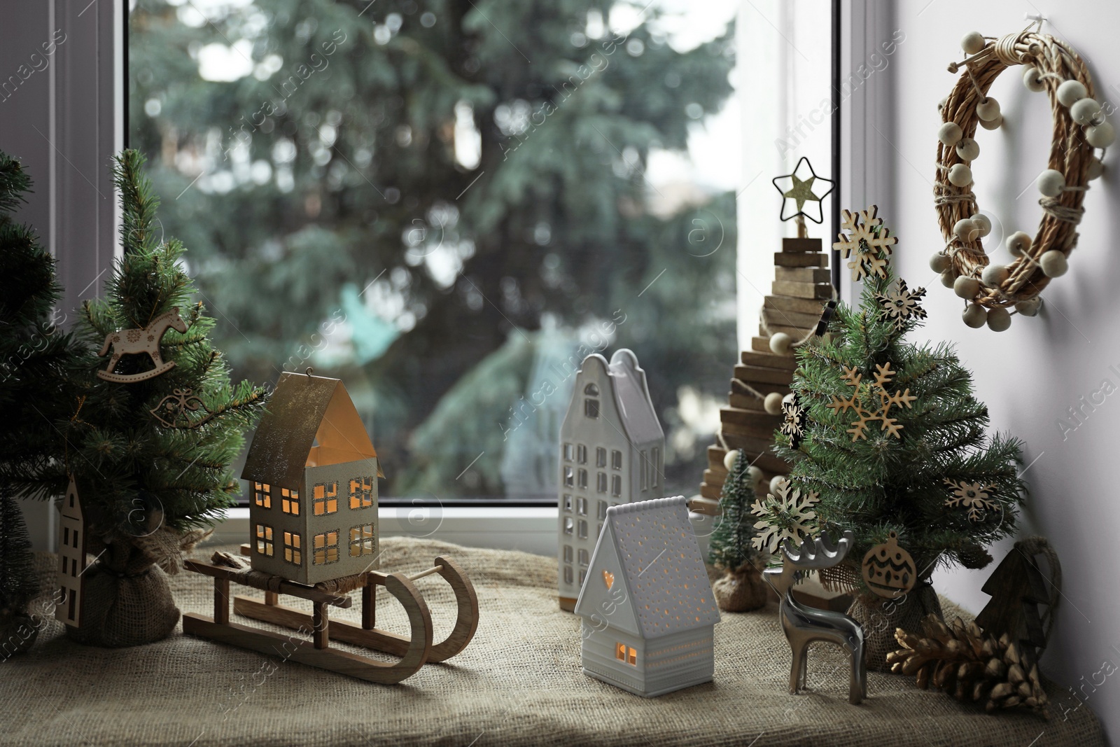 Photo of Many beautiful Christmas decorations and small fir trees on window sill indoors