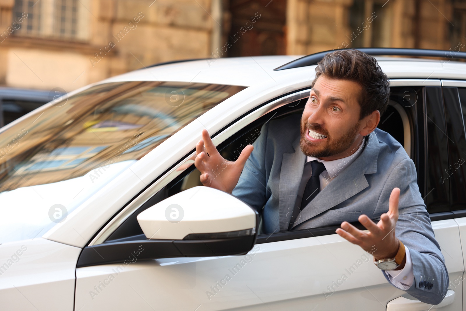 Photo of Angry driver screaming at someone from car in traffic jam