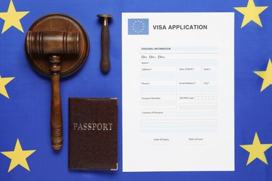 Immigration to Europe. Flat lay composition with visa application form and passport on flag