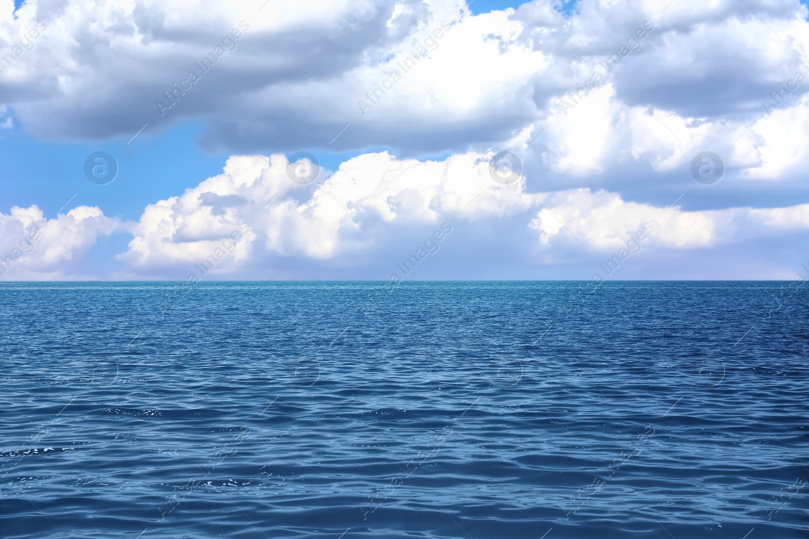 Image of Beautiful view of seascape and blue sky with white clouds on sunny day