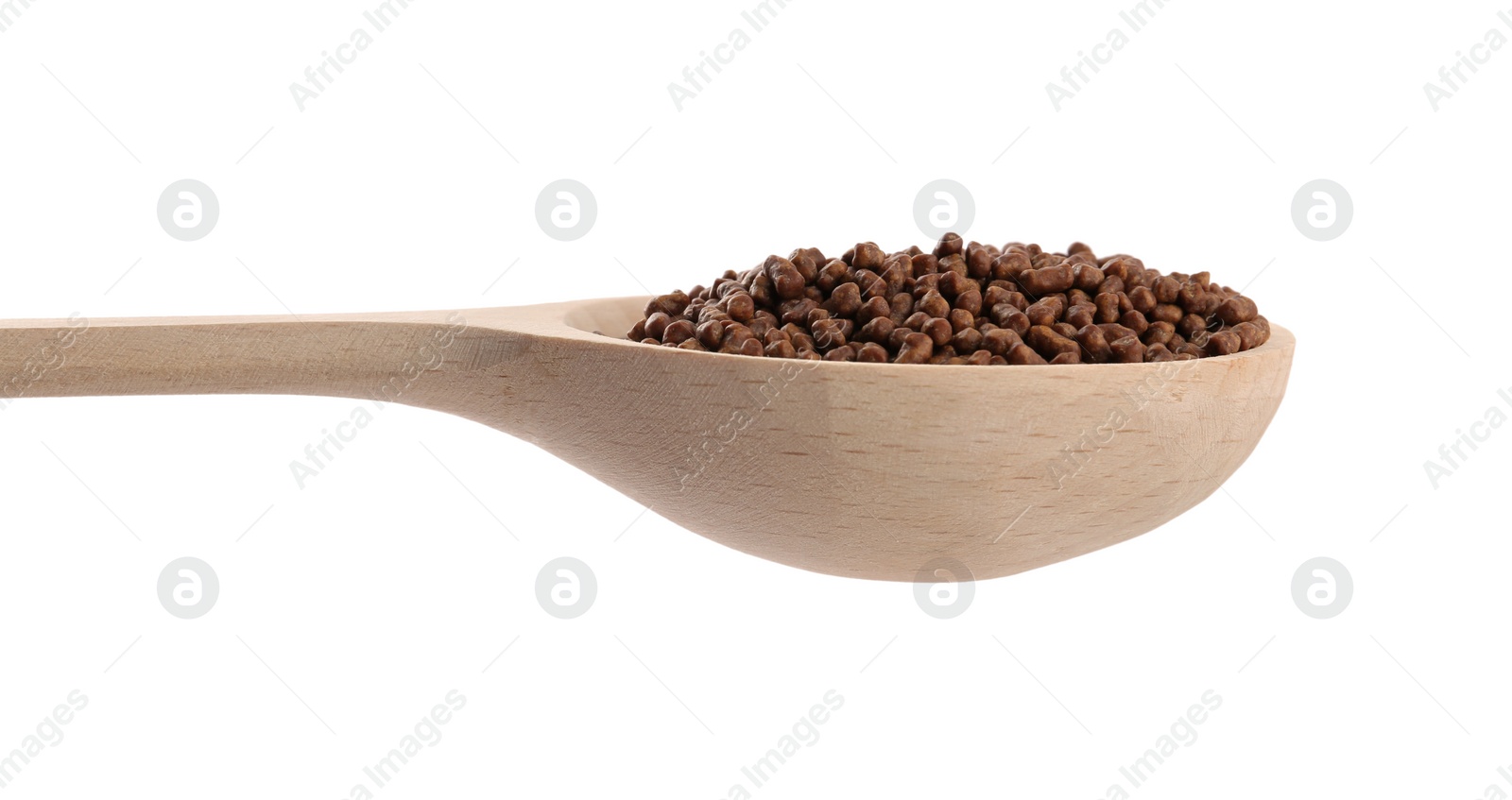 Photo of Buckwheat tea granules in wooden spoon on white background