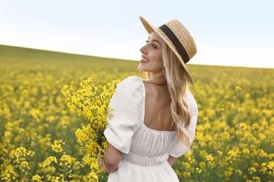 Portrait of happy young woman in field on spring day