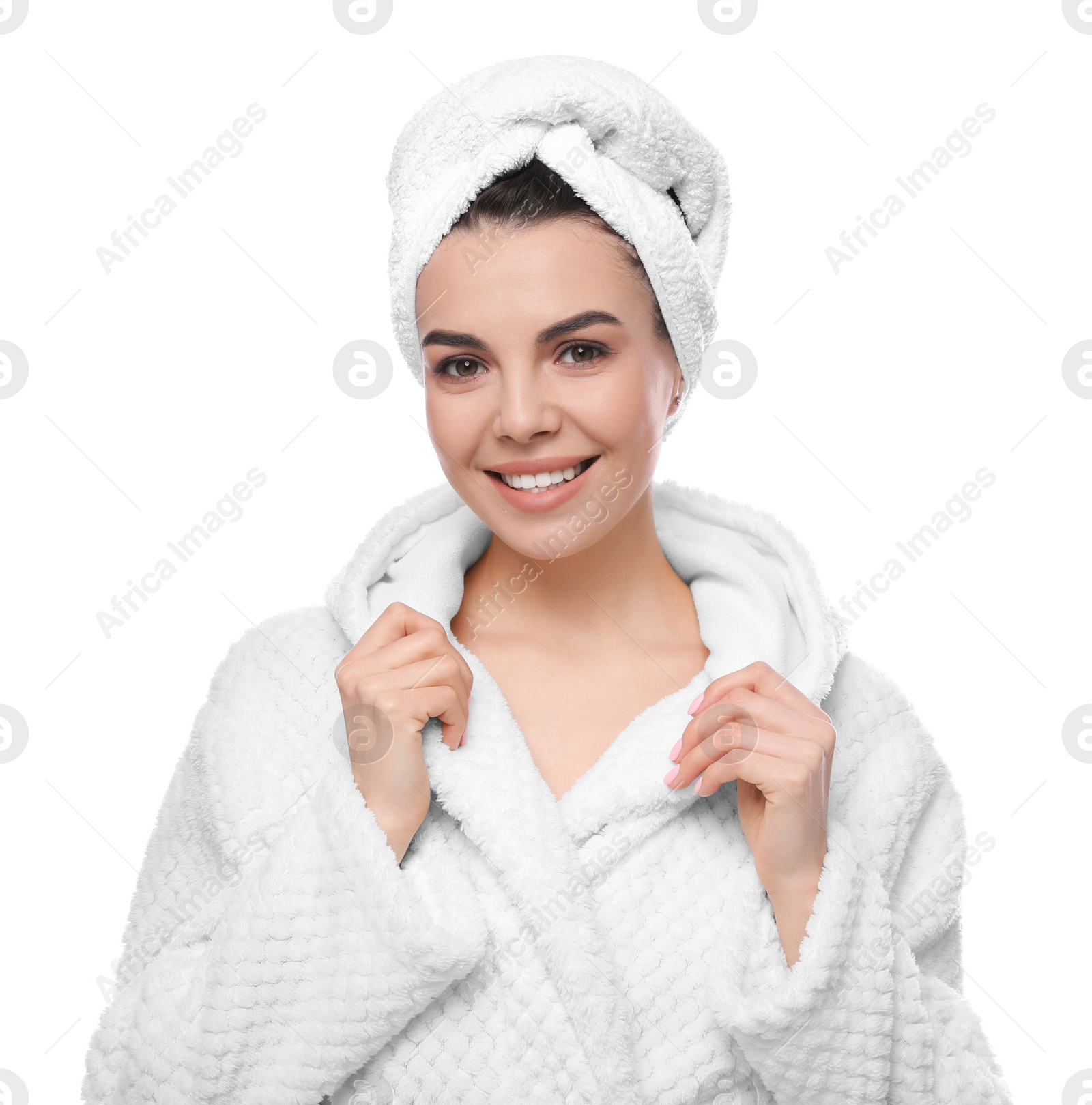 Photo of Happy young woman in bathrobe with towel on head against white background. Washing hair