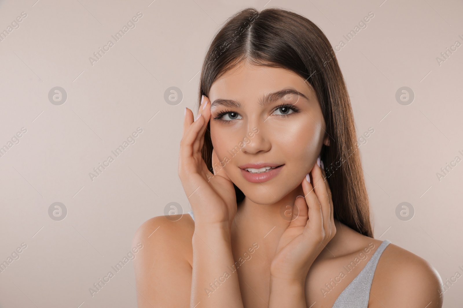 Photo of Portrait of pretty girl on light background. Beautiful face with perfect smooth skin