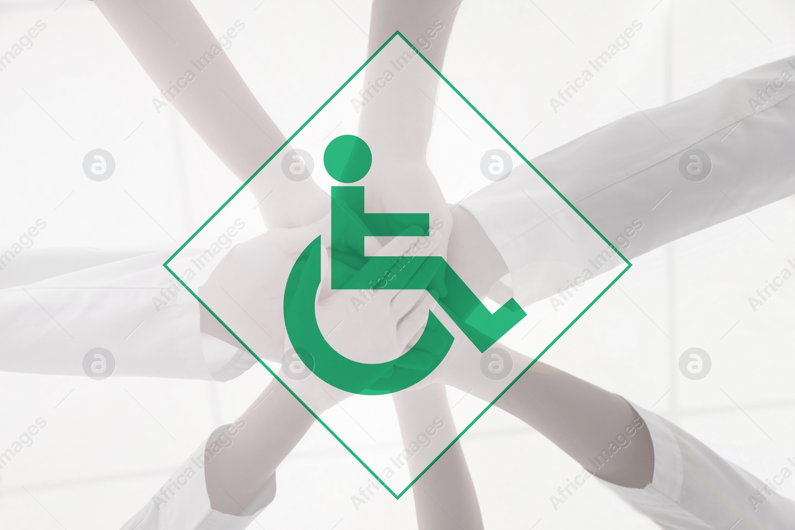 Image of Inclusive workplace culture. International symbol of access. People holding hands together, bottom view