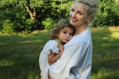 Photo of Portrait of beautiful mother with her cute daughter outdoors