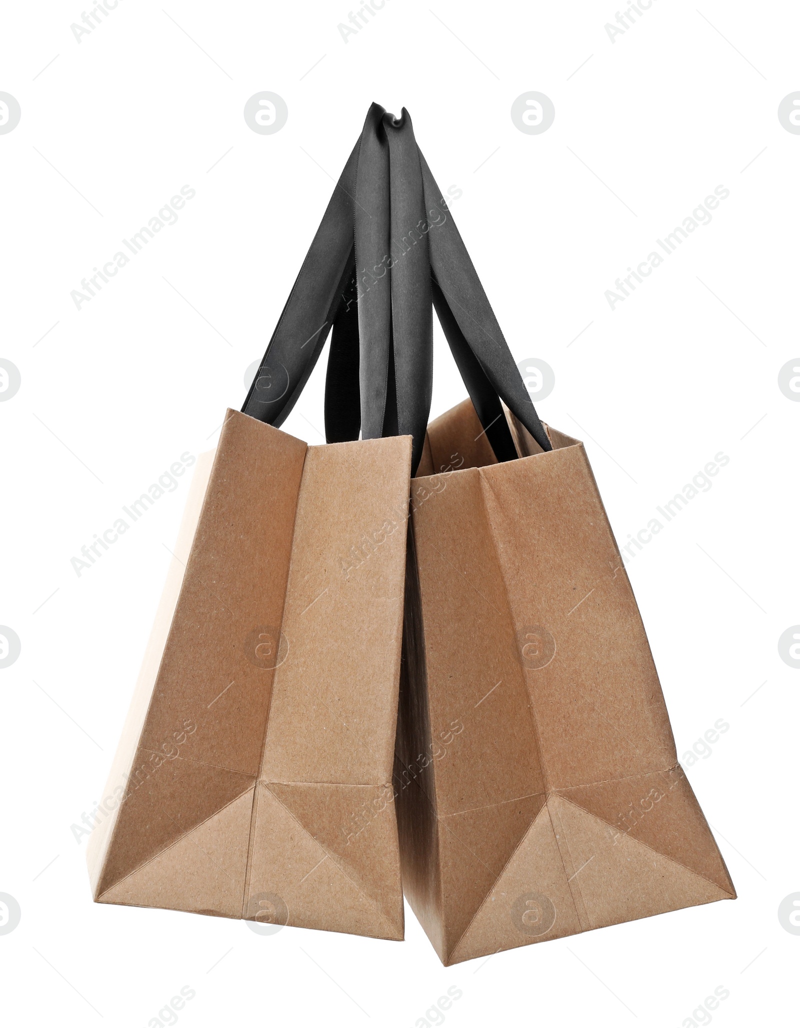 Photo of Paper shopping bags with handles on white background