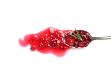 Spoon with cranberry sauce and rosemary on white background, top view