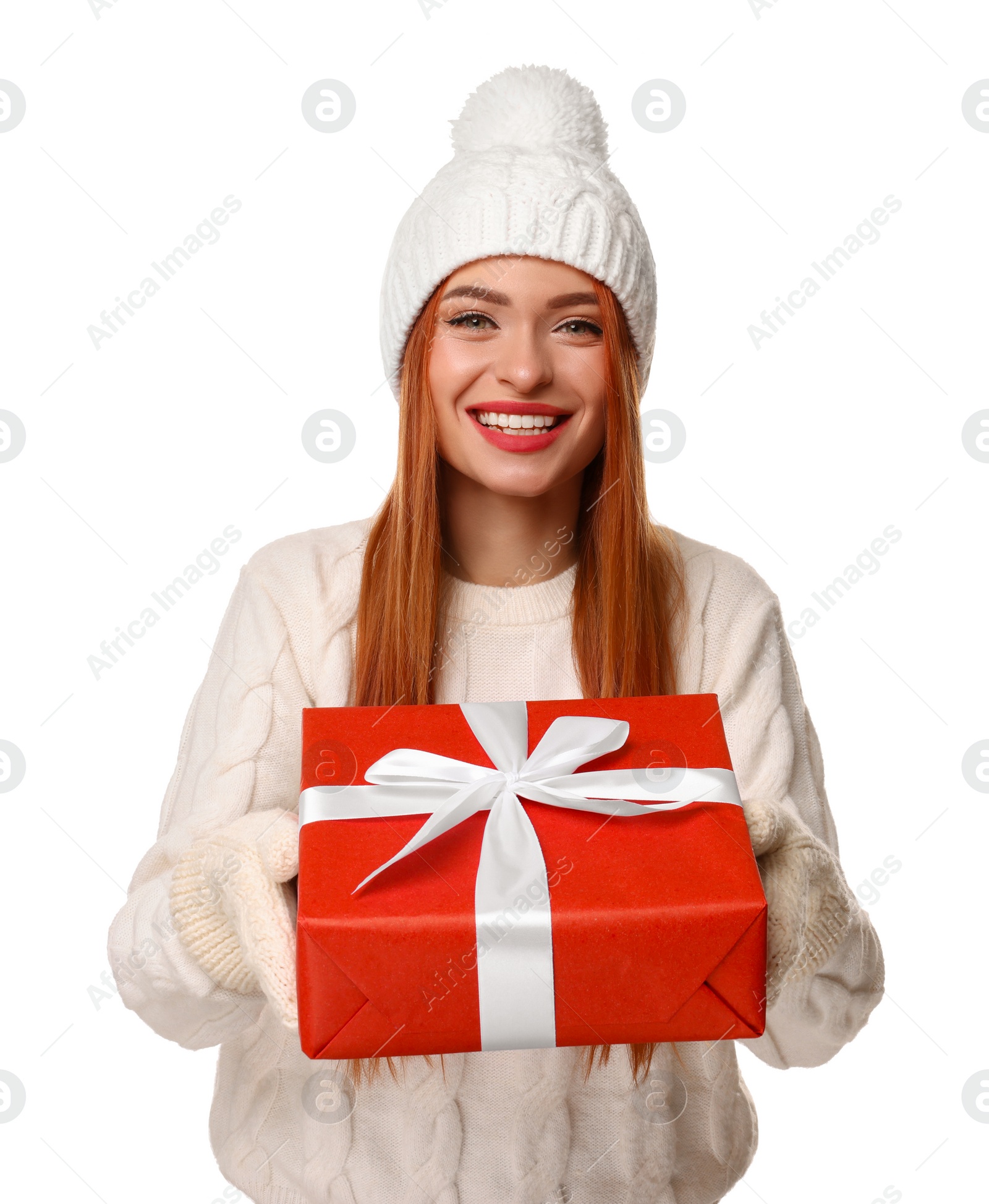 Photo of Young woman in hat and sweater with Christmas gift on white background