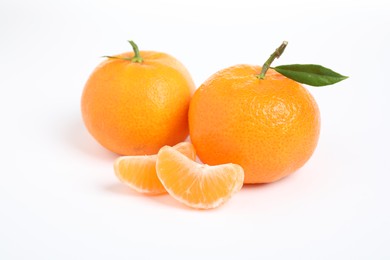 Photo of Fresh ripe tangerines with leaf isolated on white. Citrus fruit