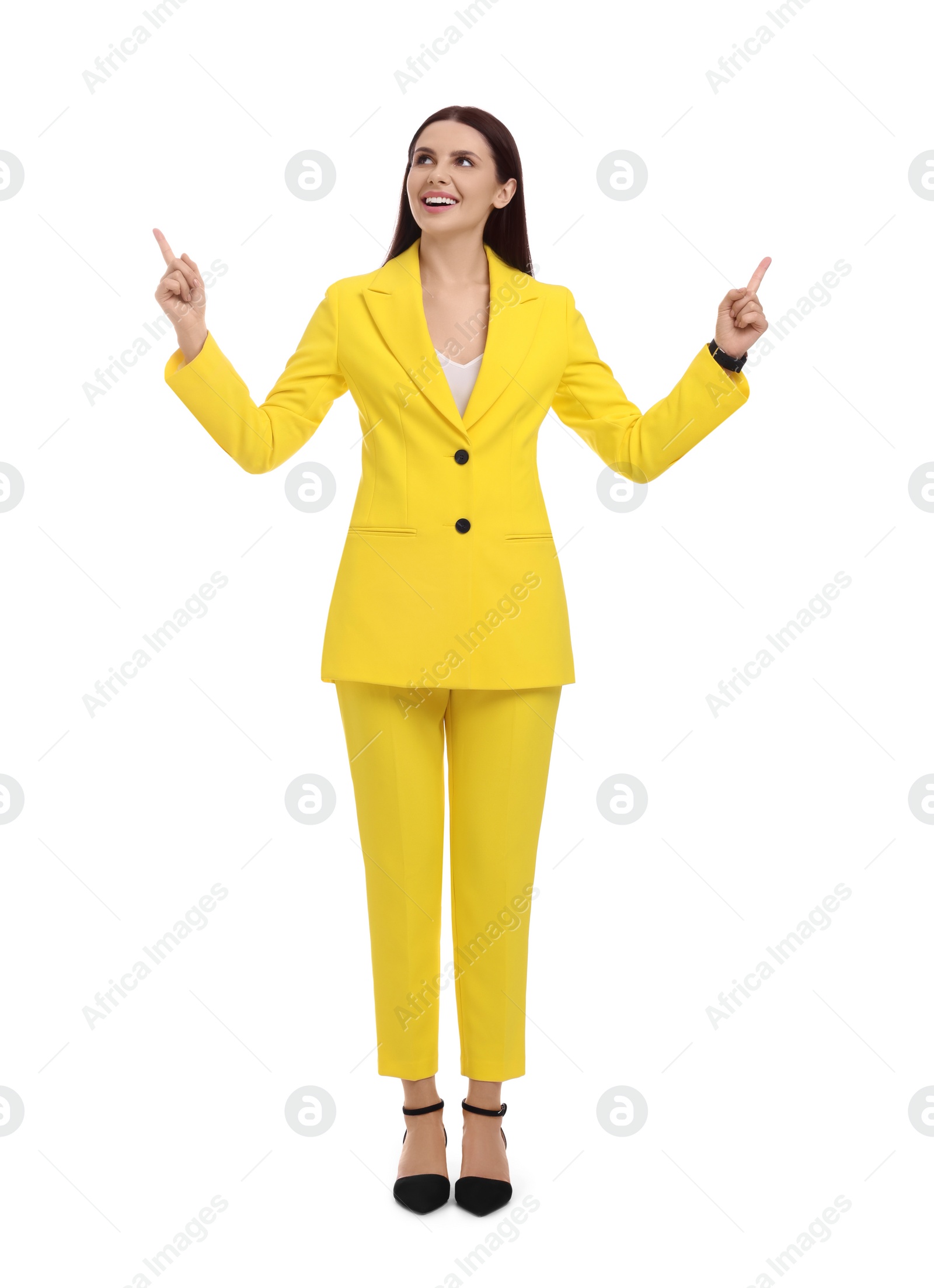 Photo of Beautiful businesswoman in yellow suit pointing at something on white background