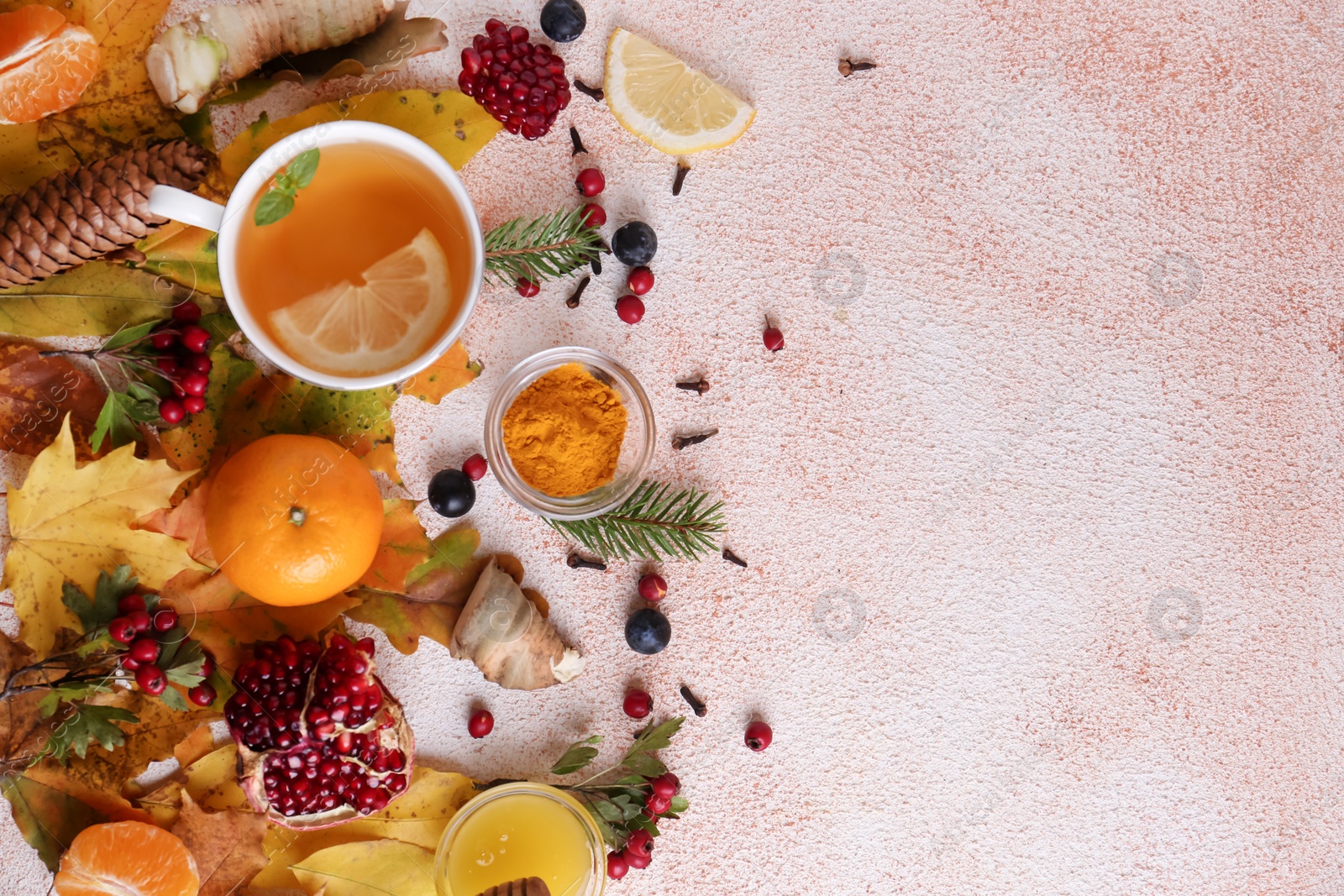 Photo of Flat lay composition with cup of delicious immunity boosting tea and ingredients on color textured background. Space for text