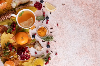 Photo of Flat lay composition with cup of delicious immunity boosting tea and ingredients on color textured background. Space for text