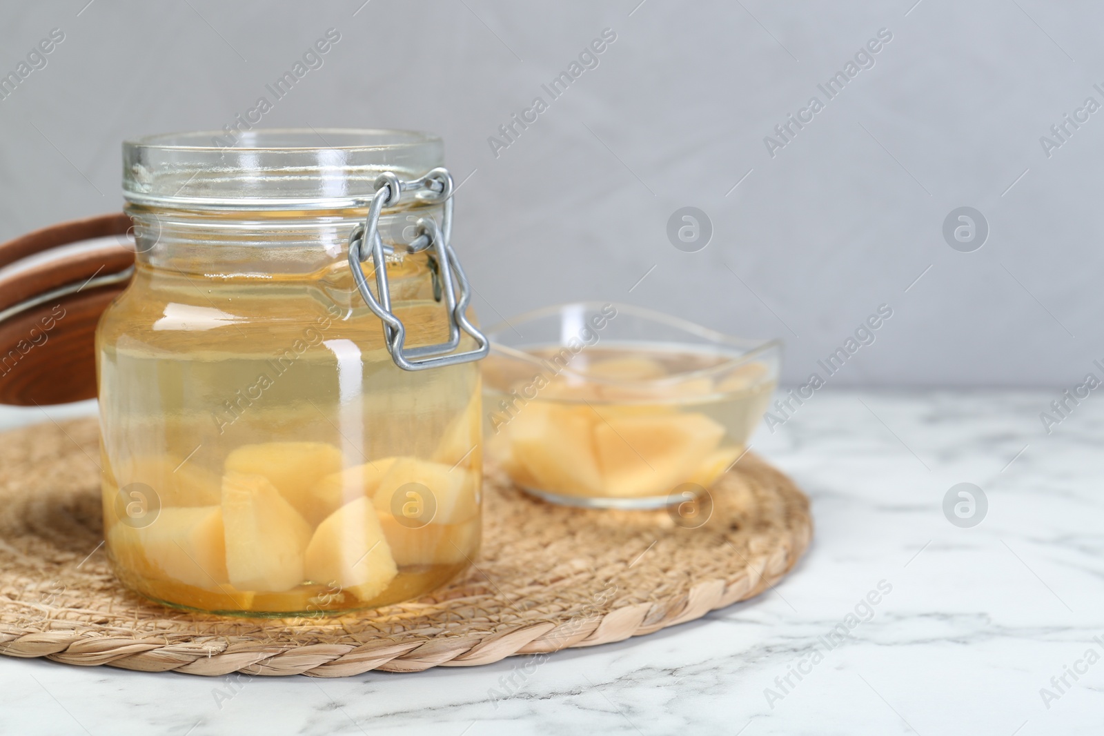 Photo of Delicious quince drink on white marble table. Space for text