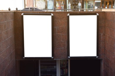 Photo of Blank posters on wall outdoors. Space for design