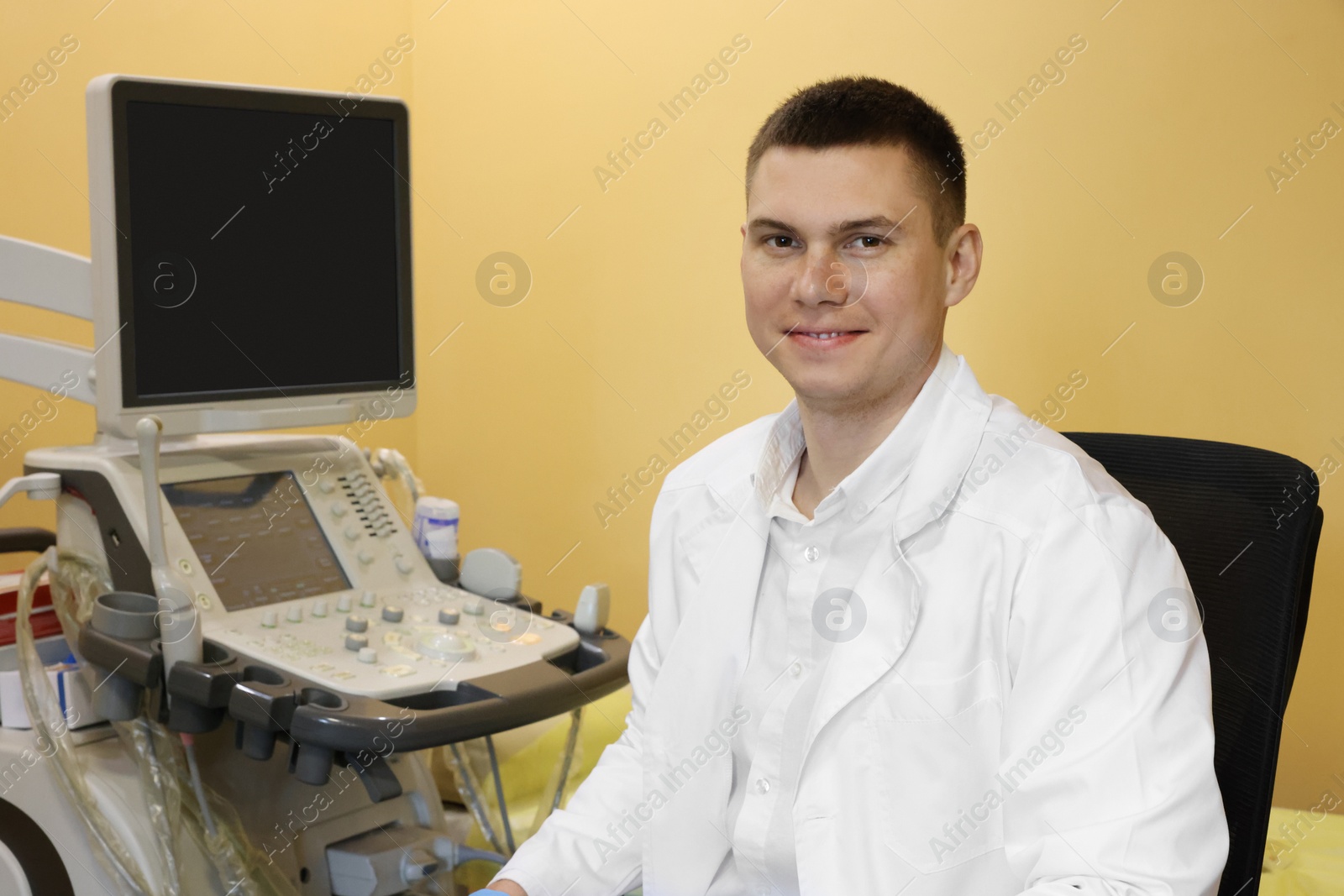 Photo of Portrait of doctor near ultrasound machine in clinic