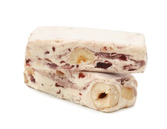 Photo of Pieces of delicious nougat on white background