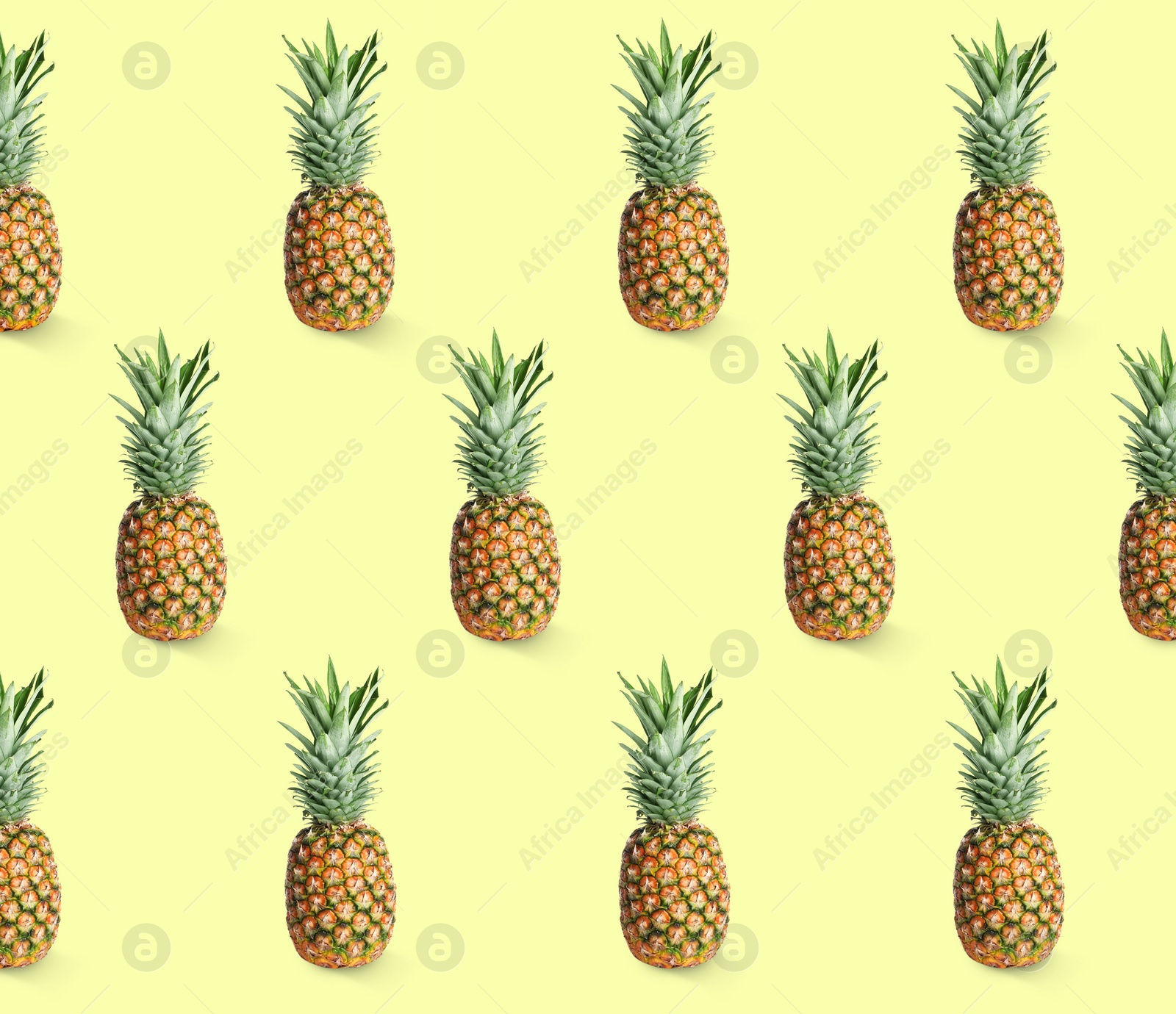 Image of Delicious ripe pineapples on yellow background. Exotic fruits