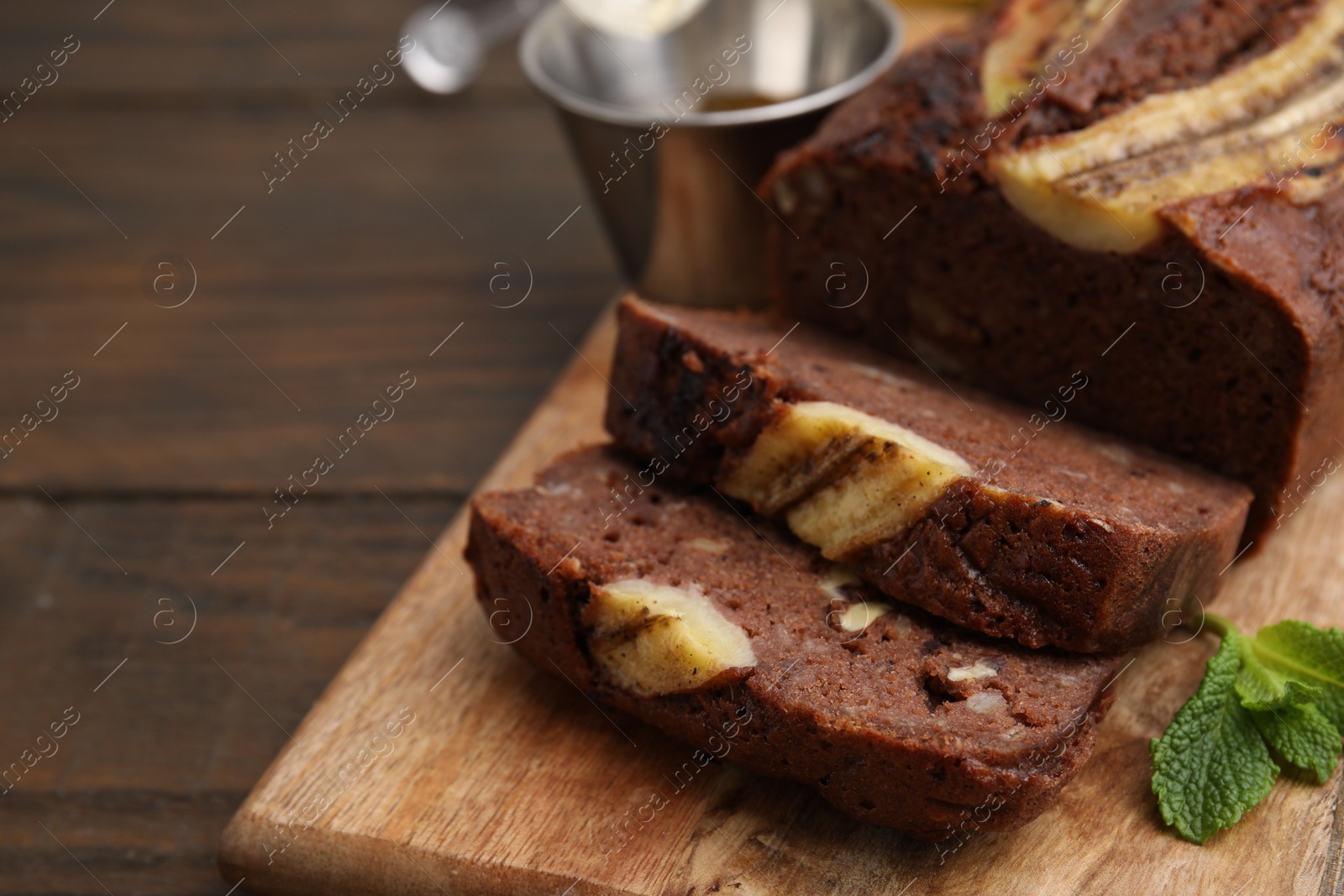 Photo of Delicious banana bread on wooden table, closeup. Space for text