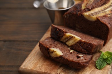 Delicious banana bread on wooden table, closeup. Space for text