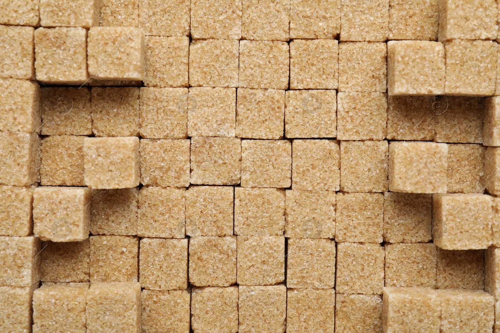 Photo of Brown sugar cubes as background, top view