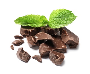 Pieces of milk chocolate with mint on white background