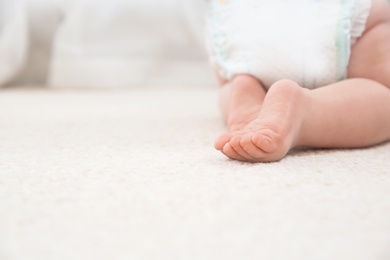 Cute little baby crawling on carpet indoors, closeup with space for text