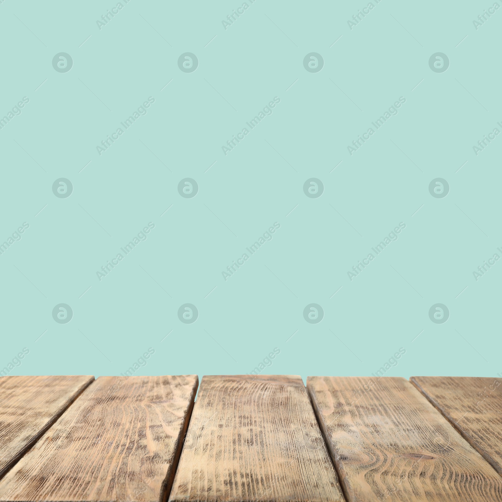 Image of Empty wooden surface on mint background. Mockup for design