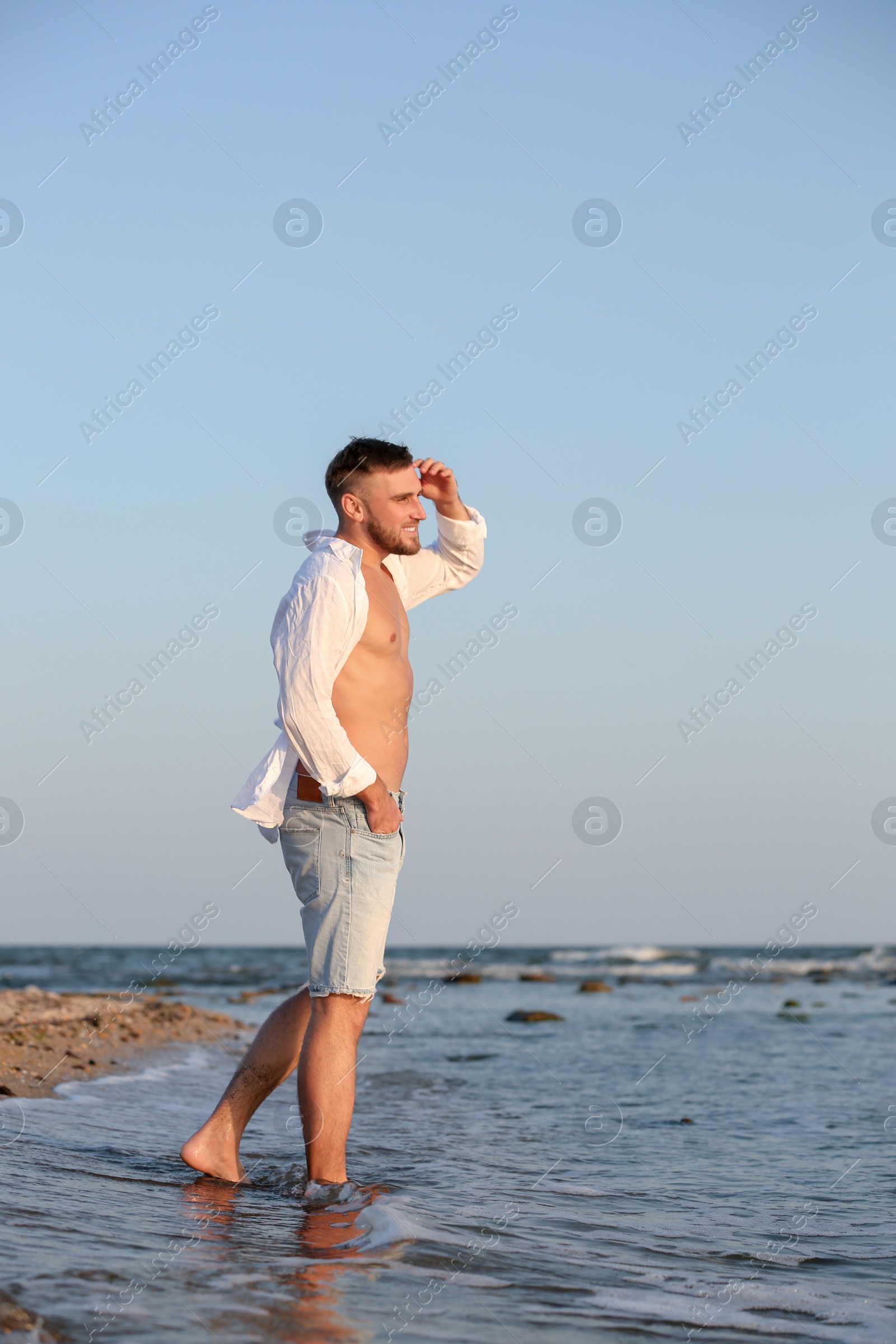 Photo of Young man enjoying sunny day on beach