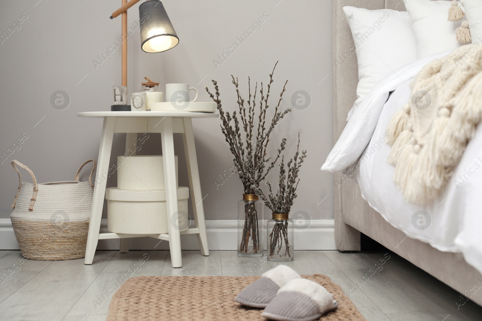 Photo of Bedroom interior with pussy willow branches and other decor