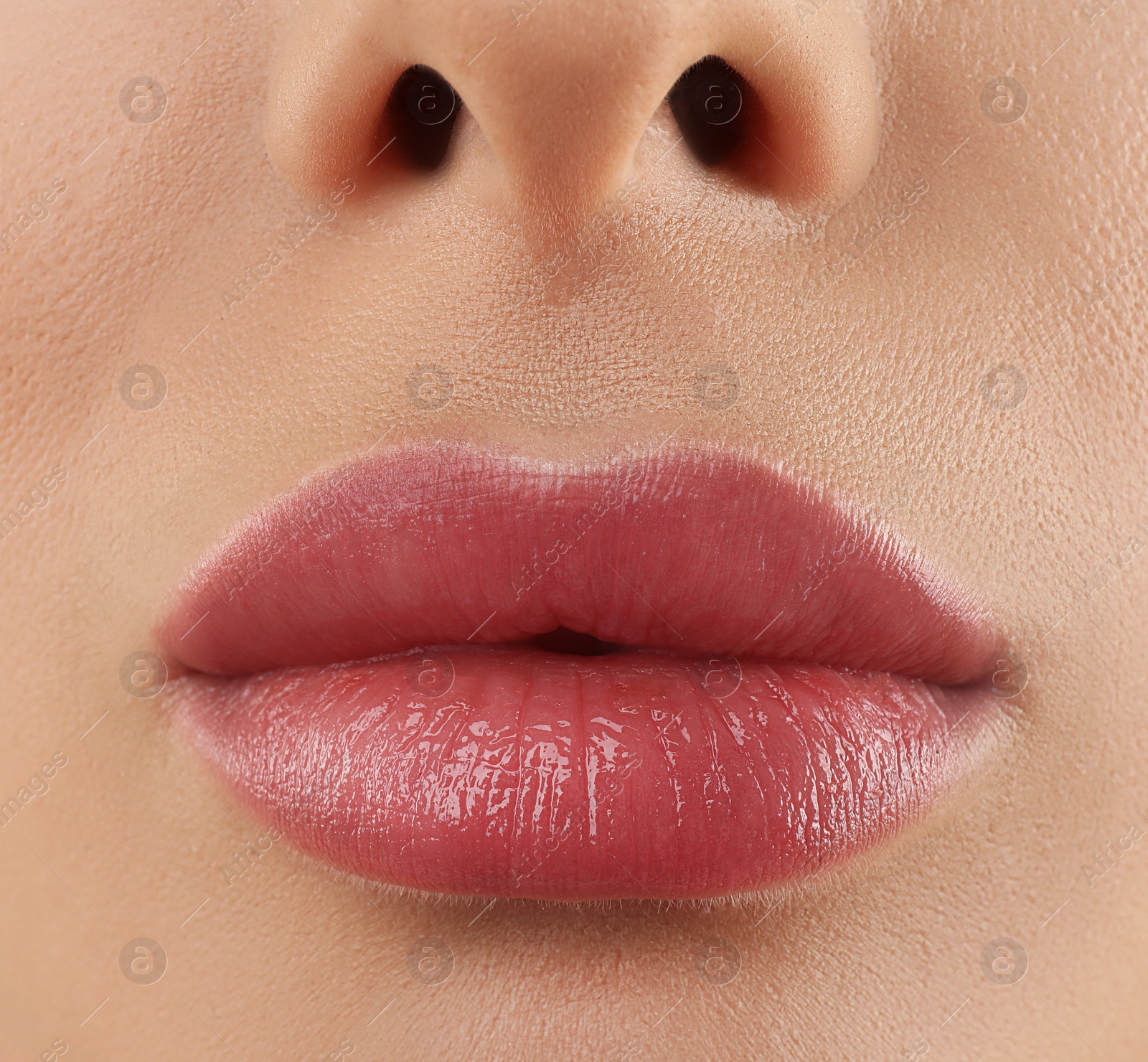 Image of Woman with beautiful perfect lips after permanent makeup procedure, closeup