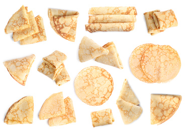 Image of Set of delicious thin pancakes on white background, top view