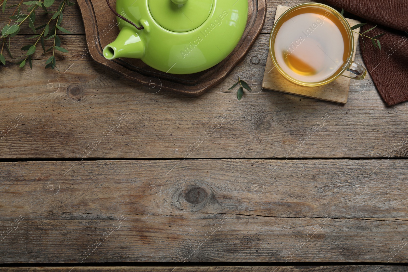 Photo of Aromatic eucalyptus tea on wooden table, flat lay. Space for text