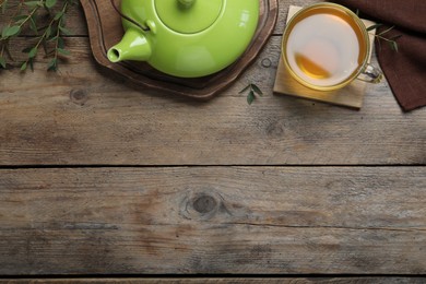 Aromatic eucalyptus tea on wooden table, flat lay. Space for text