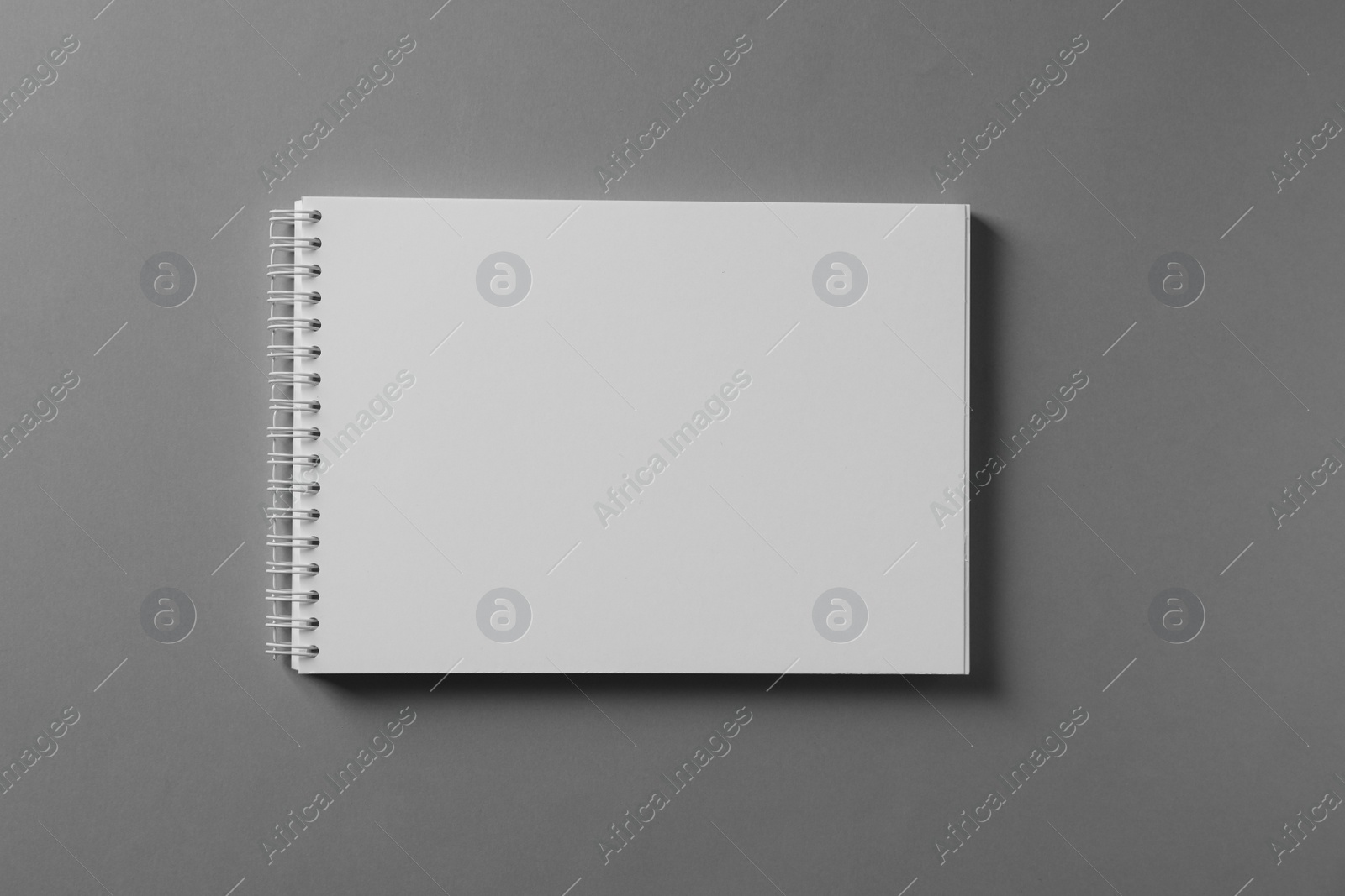 Photo of Blank notebook on light grey background, top view. Mockup for design