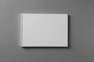 Photo of Blank notebook on light grey background, top view. Mockup for design