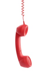 Photo of Red corded telephone handset hanging on white background. Hotline concept